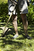 A man mowing grass