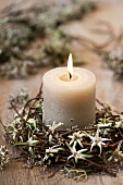 A candle in a willow wreath with edelweiss