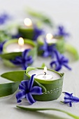 Tealights wrapped with leaves and decorated with hyacinth flowers