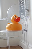 A giant rubber duck on a Philippe Starck chair
