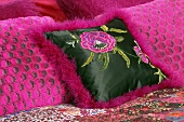 Pink decorative cushions on a bed