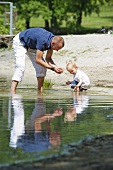 A father and his daughter playing in a lake