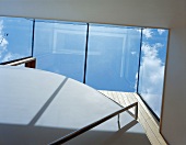 View of the sky through the glass roof of a staircase