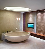 Oval, free standing bathtub with designer fittings under a round skylight