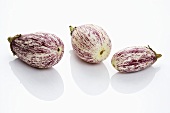 Three purple and white aubergines