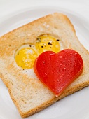 Fried eggs in toast, red pepper heart