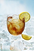 A glass of ice tea with lemons on ice