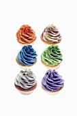 Cupcakes topped with colourful creams