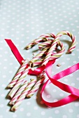 Broken candy canes and a ribbon on a dotted surface