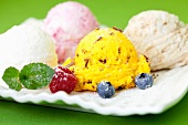Mixed ice cream with berries and mint leaves