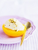 Mandarin sorbet with pistachios in a peach half