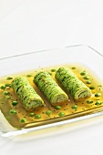 Clear beef stock with herb pancake roulade