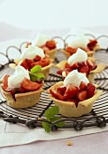 Several strawberry tarts with cream