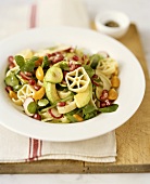 Pasta salad with vegetables and pomegranate seeds