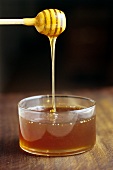 Honey running from a honey dipper
