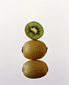 Two whole kiwi fruits and half a kiwi fruit