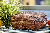 Roast beef with herbs on barbecue