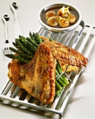 Turkey leg with green asparagus and sauce