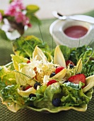 Mixed salad leaves with berries and dressing