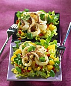 Two salad plates with squid, coriander, sweetcorn & pineapple