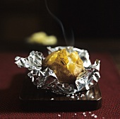 Baked potato in aluminium foil
