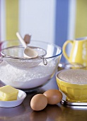 Baking still life with flour, eggs, butter & baking utensils