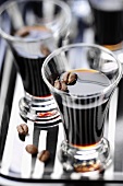 Schnapps glasses with dark liqueur and coffee beans