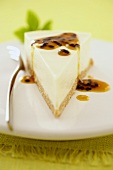 A piece of cheesecake with passion fruit sauce