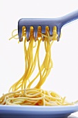 Cooked spaghetti in pasta tongs