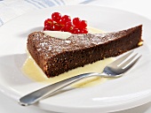 Chocolate cake in custard with redcurrants