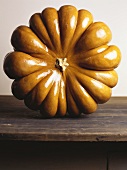 Giant pumpkin (standing up) on wooden table