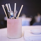 Cutlery and straws in pink container