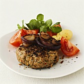 Barbecued rissoles with onions and tomatoes