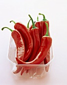 Fresh red chili peppers in plastic container