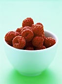 Fresh raspberries in white bowl
