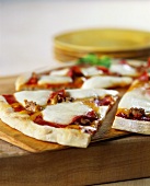 Pizza with sausage and mozzarella, a piece cut