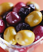 Various kinds of pickled olives in glass bowl