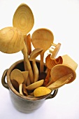 Various wooden spoons in an earthenware pot