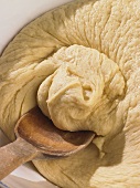 Yeast dough with wooden spoon