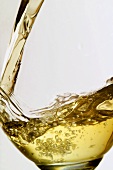 Pouring white wine into glass