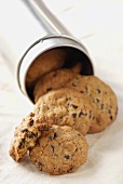 Chocolate chip cookies falling out of biscuit tin