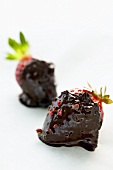 Two strawberries with chocolate sauce