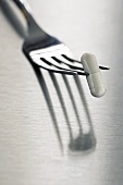 White capsule on fork