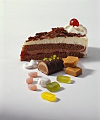 Slice of Black Forest gateau and assorted sweets