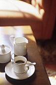 Cup of espresso, sugar bowl and cream jug