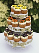 Assorted cupcakes on tiered stand in the open air