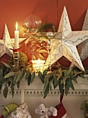 Christmas decorations with stars & candles on mantlepiece