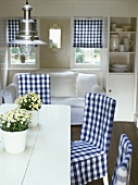 Dining table with blue & white checked chairs, white sofa