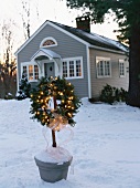 Fir wreath with lights outside a house in the country (USA)