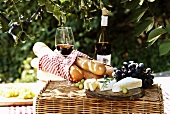 Still life with soft cheese, grapes, baguettes & red wine